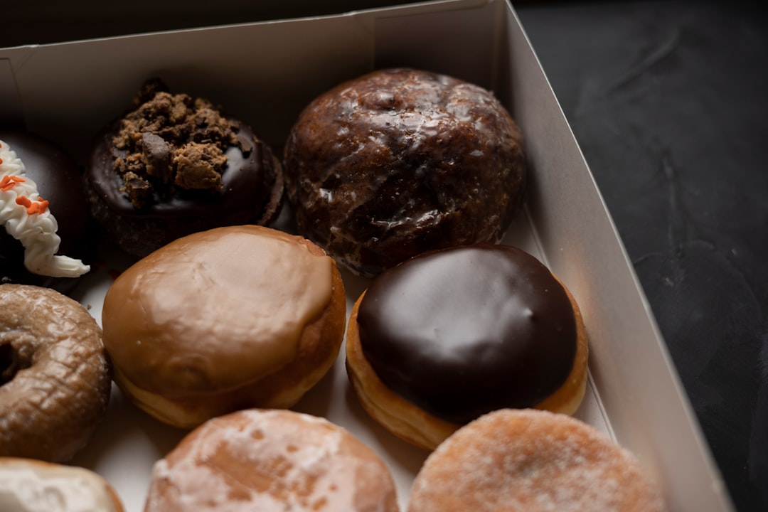 Overflowing box of handcrafted artisan doughnuts and bombolinis in vibrant colors